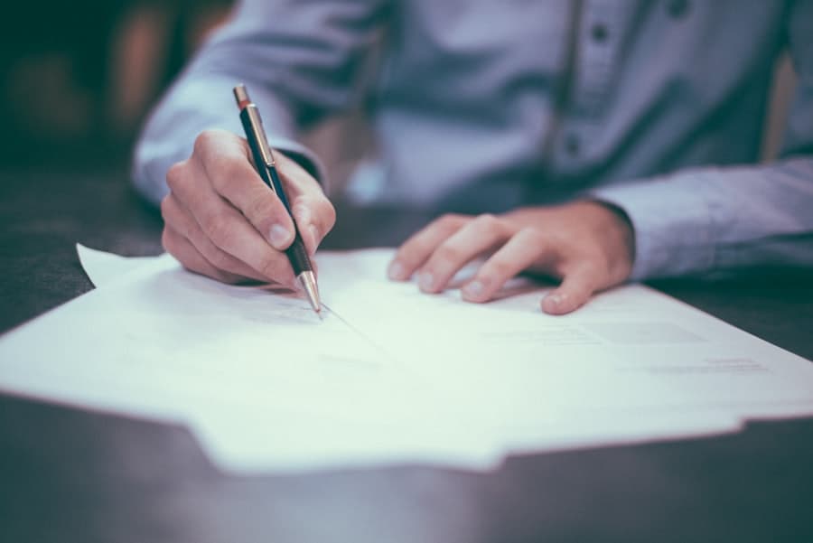 Signed documents and a fountain pen on a wooden desk